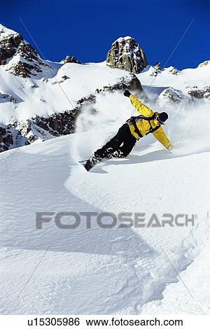 Snowboarder coming down snowy hill View Large Photo Image Stock Photograph - Snowboarder coming down snowy hill. Fotosearch