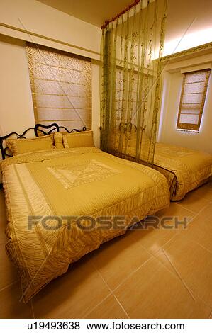 Stock Photo - Home interior and beds in the bedroom. Fotosearch