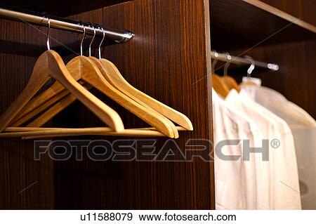 Stock Photo - Close-up of hangers in the closet. Fotosearch