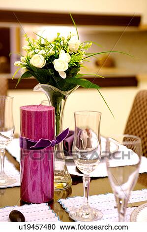 Stock Image - Close-up of place settings and decorations on the dining table. Fotosearch