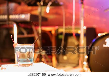 Stock Photo - Close-up of a glass of cocktail on the table . Fotosearch