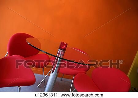 Stock Image - Interiors-leisure space with table and styled chairs. Fotosearch