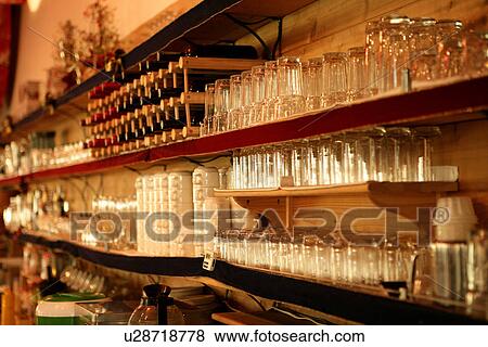 Stock Photo - Wineglass shelf with wineglasses in the bar counter. Fotosearch