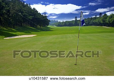 Flag in golf course View Large Photo Image Stock Photo - Flag in golf course. Fotosearch