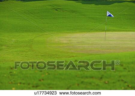 Flag in putting green View Large Photo Image Stock Image - Flag in putting green. Fotosearch
