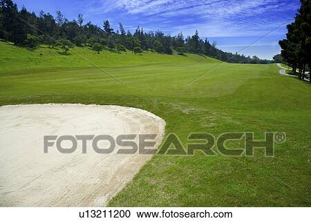 Stock Image - Sand trap in golf course. Fotosearch