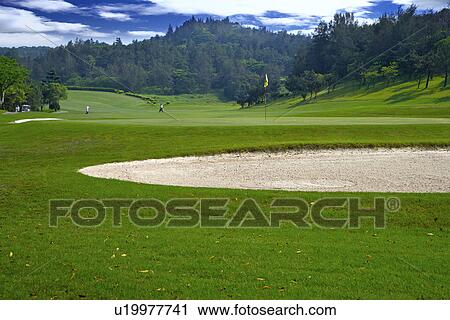 Stock Image - Sand trap in golf course. Fotosearch