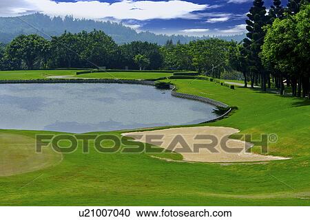 Stock Image - Water hazard in golf course. Fotosearch