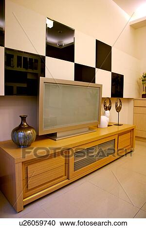 Stock Image - Modern style living room with flat screen on side cabinet. Fotosearch