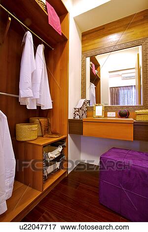 Interiors of a walk-in wardrobe and dressing table View Large Photo Image Stock Photo - Interiors of a walk-in wardrobe and dressing table. Fotosearch