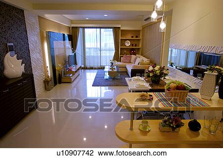 Stock Image - Modern style living room with dinning table. Fotosearch