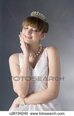 Portrait of teenage girl wearing crown and jewelries, eyes closed View Large Photo Image Stock Image - Portrait of teenage girl wearing crown and jewelries, eyes closed. Fotosearch