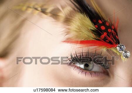 Studio shot of teenage girl with makeup and feather View Large Photo Image Picture - Studio shot of teenage girl with makeup and feather. Fotosearch