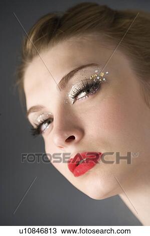 Stock Image - Studio shot of teenage girl with makeup. Fotosearch