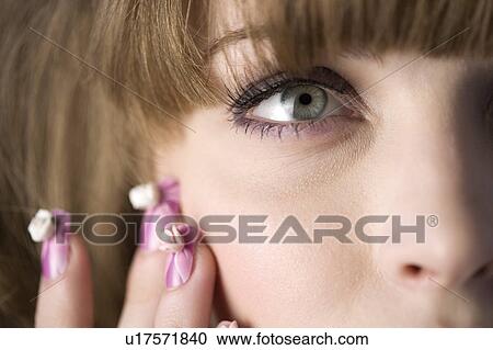 Studio shot of teenage girl with makeup and artificial fingernails View Large Photo Image Stock Image - Studio shot of teenage girl with makeup and artificial fingernails. Fotosearch