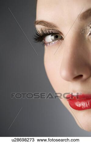 Stock Image - Studio shot of teenage girl with makeup. Fotosearch