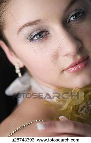 Stock Image - Studio shot of teenage girl with makeup and neckerchief with flower. Fotosearch