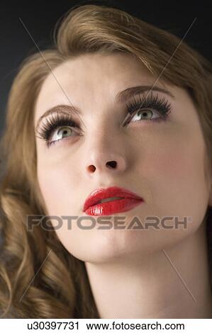 Stock Image - Studio shot of teenage girl with makeup. Fotosearch