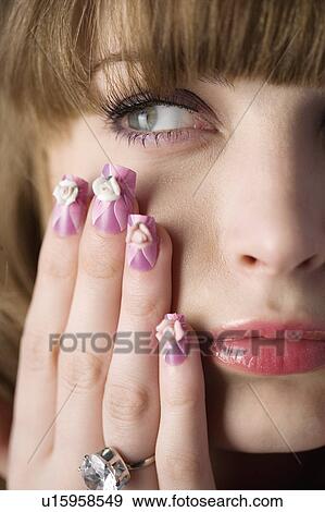 Studio shot of teenage girl with makeup and artificial fingernails View Large Photo Image Stock Photo - Studio shot of teenage girl with makeup and artificial fingernails. Fotosearch