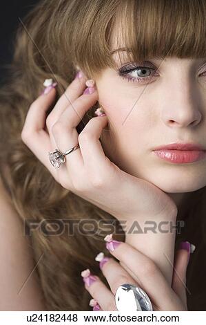Studio shot of teenage girl with makeup and artificial fingernails View Large Photo Image Stock Photo - Studio shot of teenage girl with makeup and artificial fingernails. Fotosearch