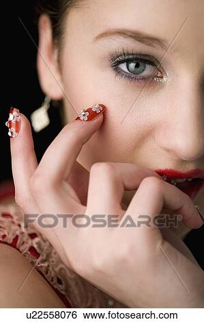 Studio shot of teenage girl with makeup and artificial fingernails View Large Photo Image Stock Photograph - Studio shot of teenage girl with makeup and artificial fingernails. Fotosearch