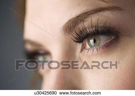 Stock Image - Studio shot of teenage girl with makeup, focus on eyes. Fotosearch
