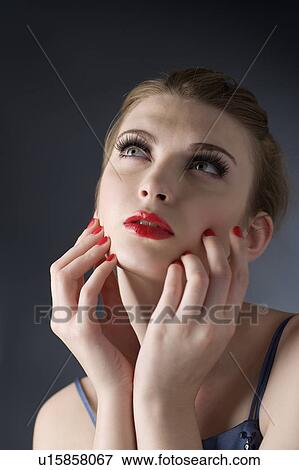 Studio shot of teenage girl with makeup, looking up View Large Photo Image Stock Photo - Studio shot of teenage girl with makeup, looking up. Fotosearch