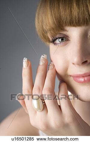 Studio shot of teenage girl with makeup, ring and artificial fingernails View Large Photo Image Stock Photography - Studio shot of teenage girl with makeup, ring and artificial fingernails. Fotosearch