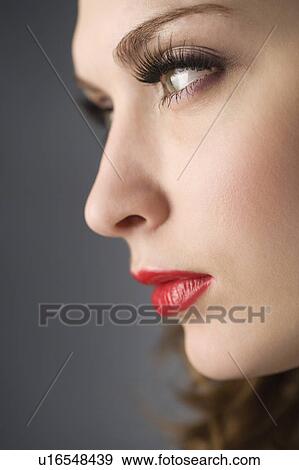 Stock Photo - Studio shot of teenage girl's face, side view. Fotosearch