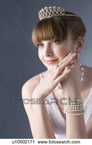 Stock Image - Teenage girl wearing jewelries smiling, portrait, Blue Eyes,. Fotosearch