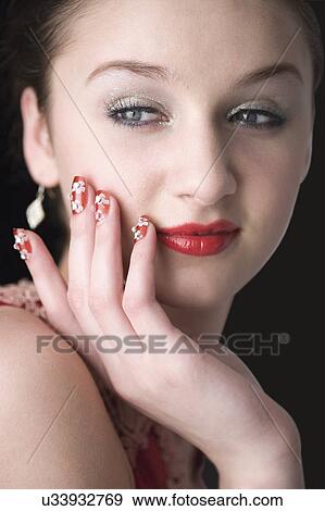 Stock Photo - Teenage girl with makeup and artificial fingernails. Fotosearch
