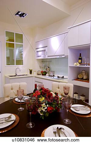 Stock Photograph - Table setting in modern style kitchen. Fotosearch
