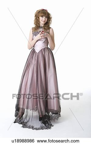 Teenage girl in formal dress holding a glass of wine View Large Photo Image Stock Photograph - Teenage girl in formal dress holding a glass of wine. Fotosearch