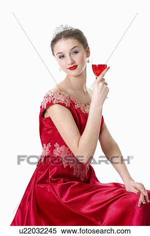 Stock Photography - Teenage girl in formal dress holding a glass of wine. Fotosearch