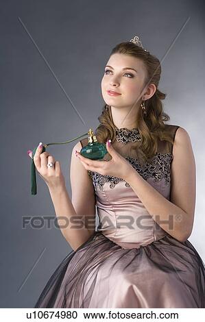 Teenage girl in formal dress holding perfume sprayer View Large Photo Image Stock Image - Teenage girl in formal dress holding perfume sprayer. Fotosearch