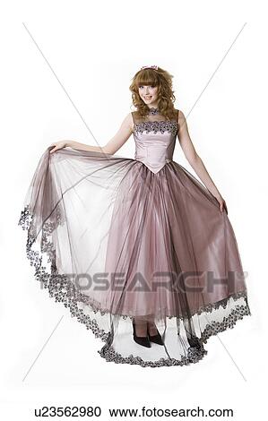 Stock Image - Teenage girl in formal dress, studio shot. Fotosearch