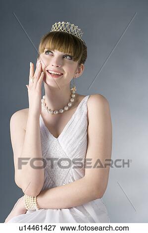 Teenage girl in formal dress touching cheeks View Large Photo Image Stock Photo - Teenage girl in formal dress touching cheeks. Fotosearch