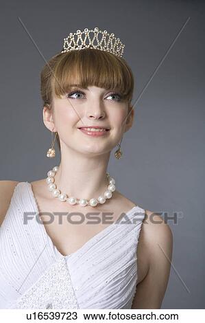 Teenage girl in formal dress wearing jewelries View Large Photo Image Stock Image - Teenage girl in formal dress wearing jewelries. Fotosearch