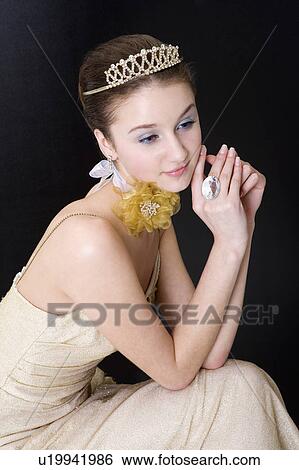 Stock Photograph - Teenage girl in formal dress wearing crown. Fotosearch