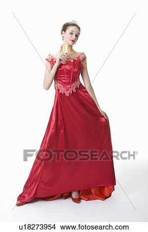 Picture - Teenage girl wearing formal dress holding a glass of wine. Fotosearch
