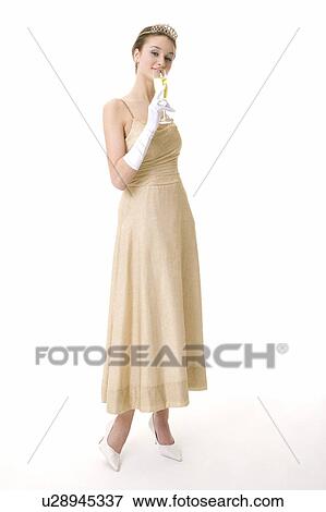 Stock Photo - Teenage girl wearing formal dress holding a glass of wine. Fotosearch