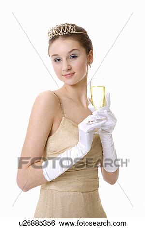 Teenage girl wearing formal dress holding a glass of beer View Large Photo Image Stock Photograph - Teenage girl wearing formal dress holding a glass of beer. Fotosearch