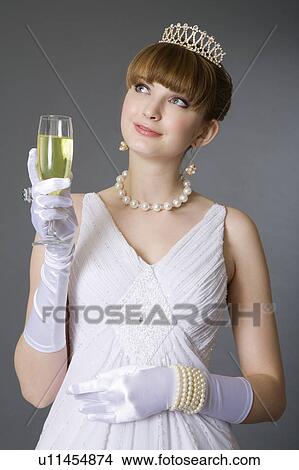 Teenage girl wearing jewelries holding a glass of wine View Large Photo Image Picture - Teenage girl wearing jewelries holding a glass of wine. Fotosearch