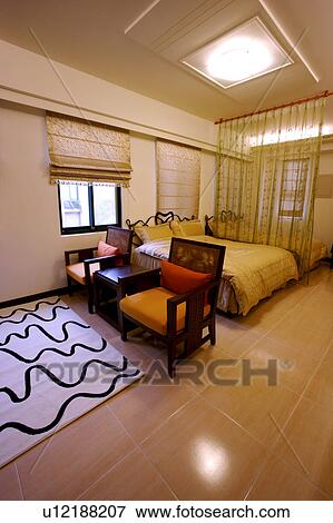 Stock Photo - Chairs and bed in room. Fotosearch