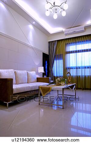 Stock Image - Sofa, lamp and coffee table in living room. Fotosearch