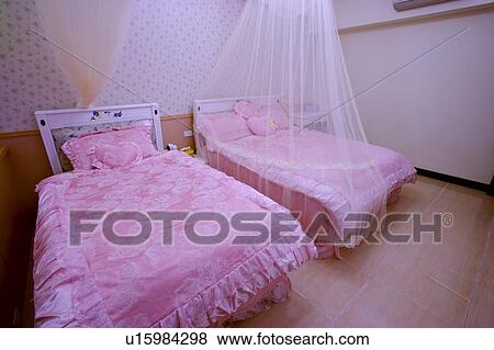 Stock Photo - Two pink beds in bedroom. Fotosearch