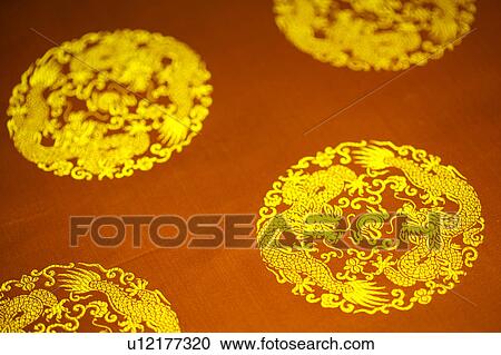 Stock Image - Chinese style totem on red fabric. Fotosearch