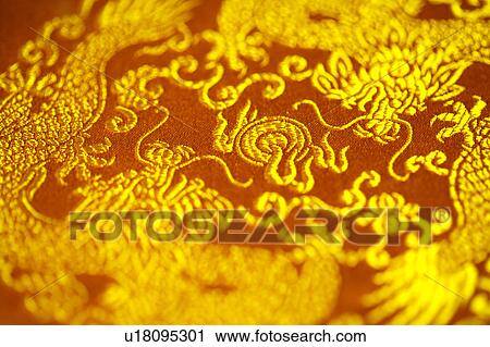 Stock Image - Chinese style totem on red fabric. Fotosearch