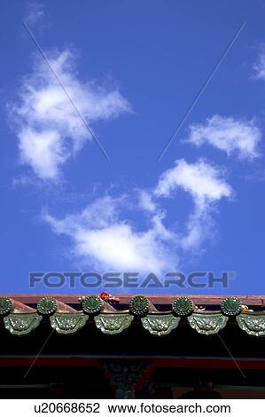 Stock Image - Chinese traditional building against blue sky, focus on roof. Fotosearch
