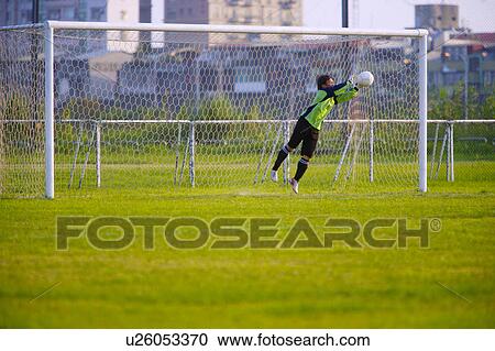 Football goalie diving for ball View Large Photo Image Stock Image - Football goalie diving for ball. Fotosearch